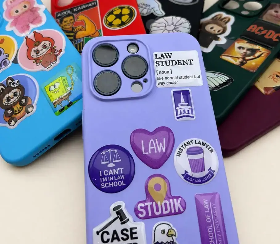 Phone cases decorated with domed stickers, the raised gloss domes catching the light