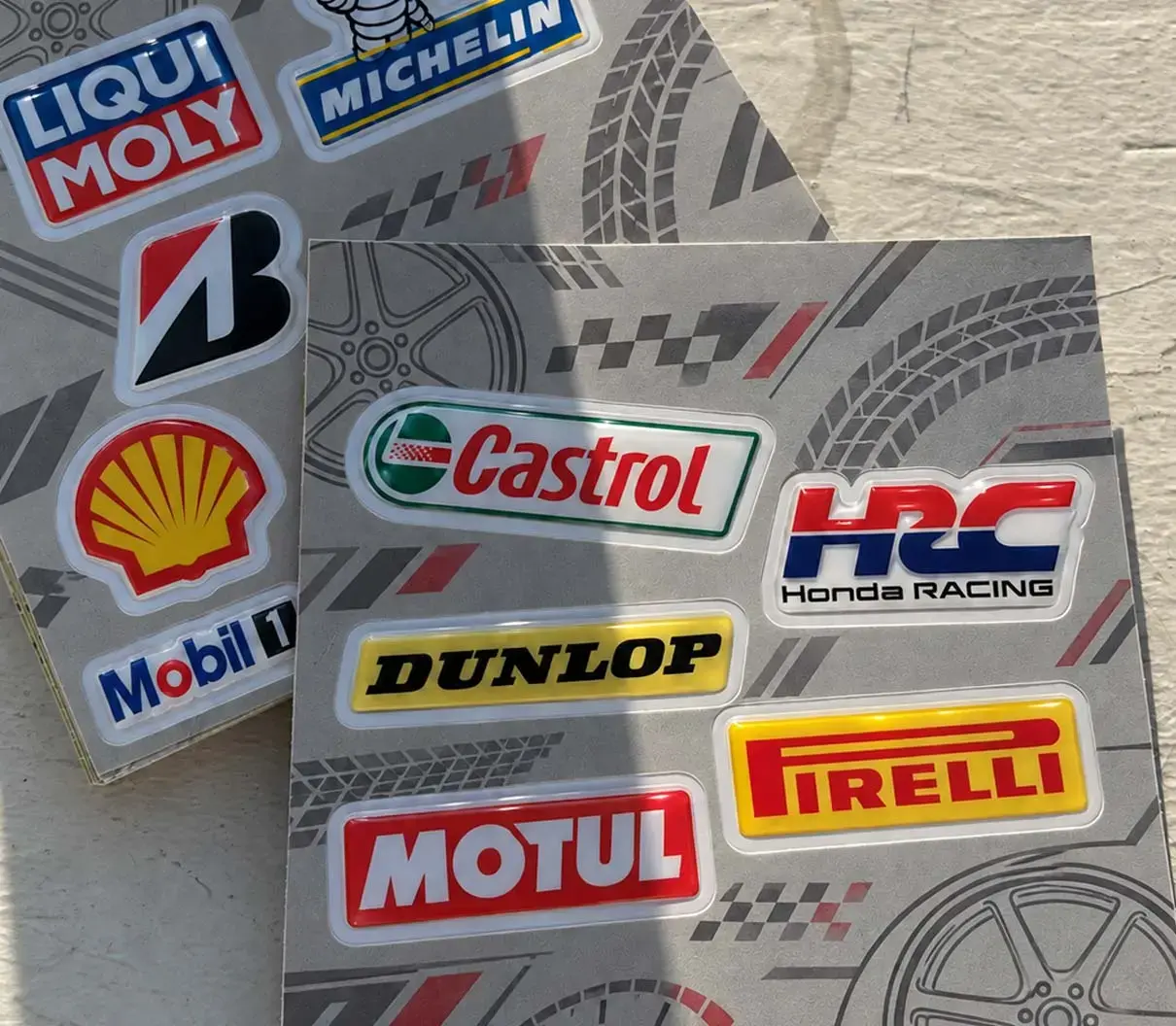 Sheet of finished automotive decals lit from the side