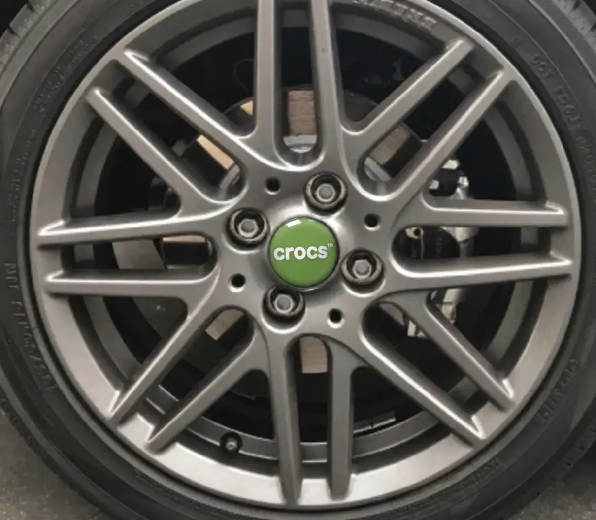 Round domed logo sticker on the centre cap of an alloy wheel