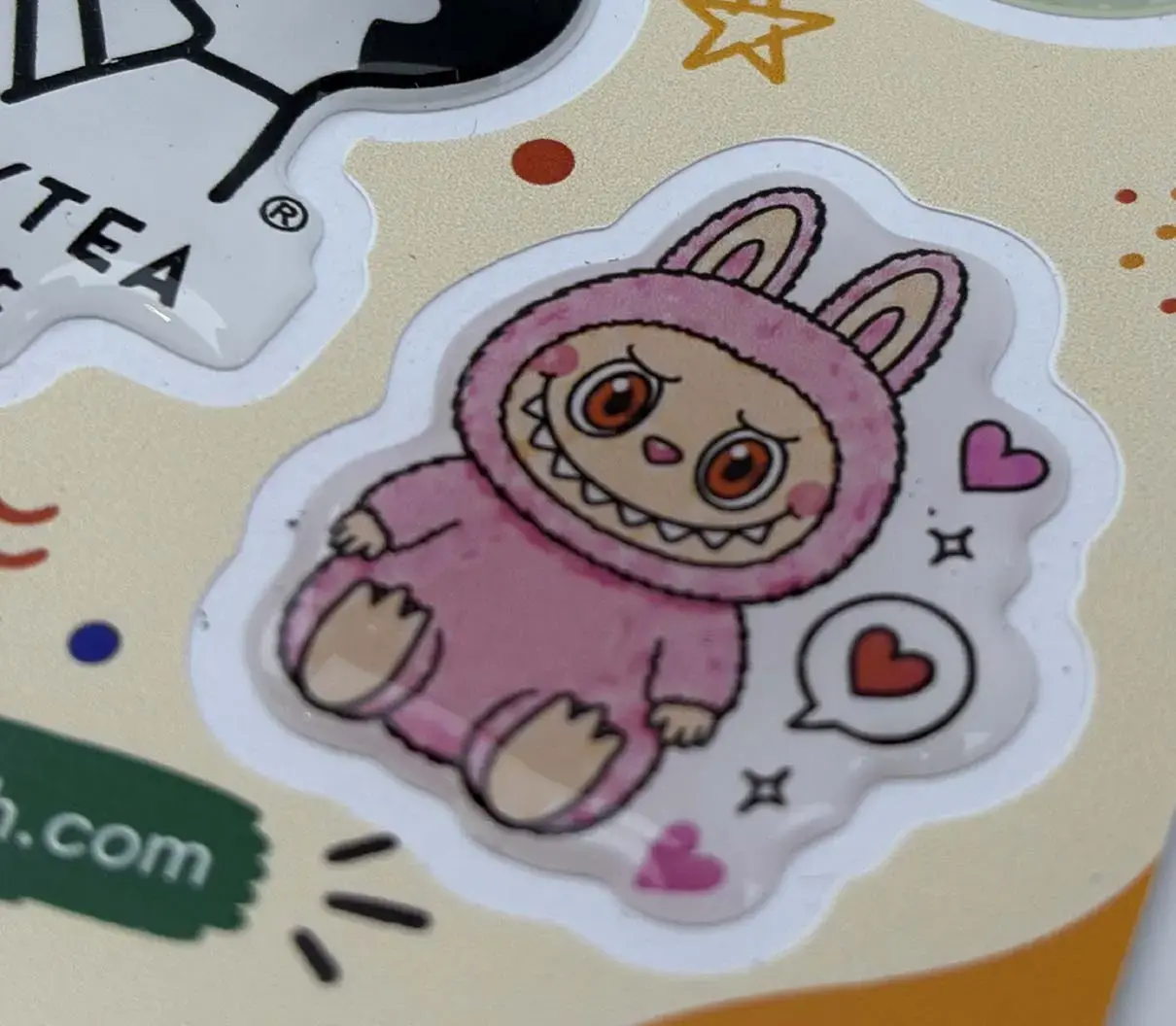 Single domed sticker close up, showing dome thickness at the cut edge