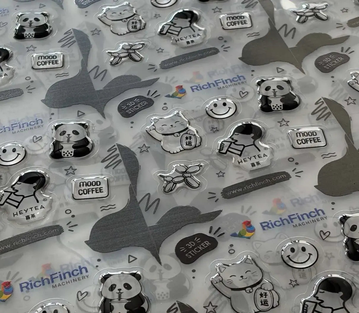 Sheet of clear and silver domed stickers laid flat on a table