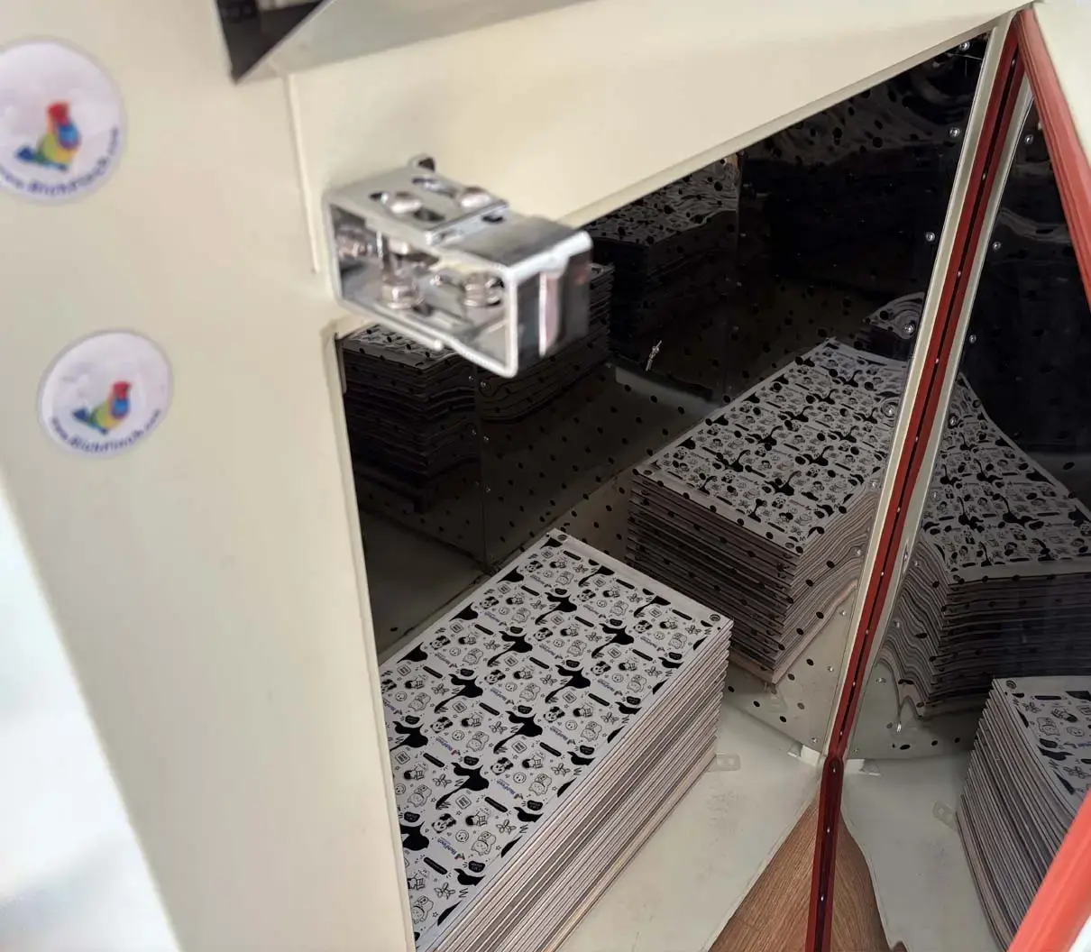 Sheet of domed stickers curing in the heated curing oven