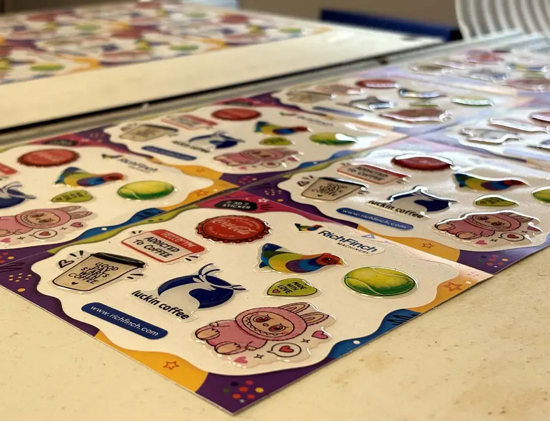 Sheet of domed stickers photographed at an angle, showing the raised dome